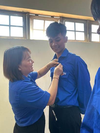 ''A person helping a child buttoning a shirt

AI-generated content may be incorrect.''